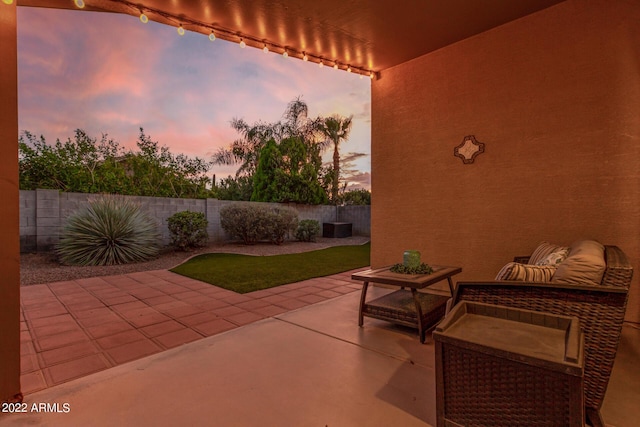 view of patio terrace at dusk