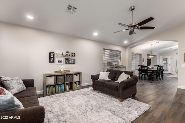 living room with vaulted ceiling, dark hardwood / wood-style floors, and ceiling fan