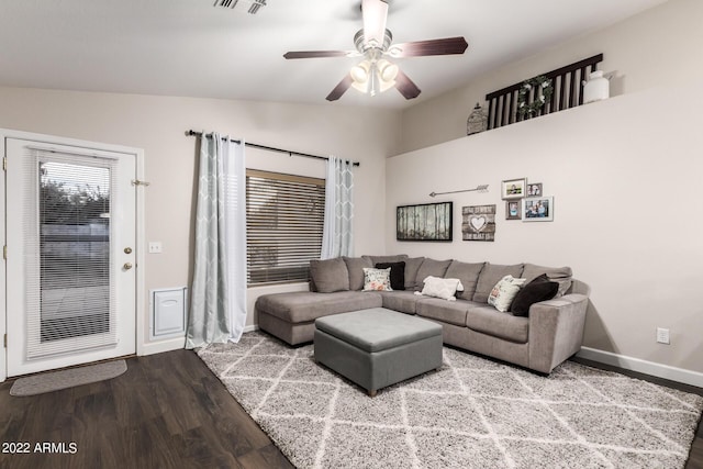 living room featuring wood-type flooring, vaulted ceiling, and ceiling fan