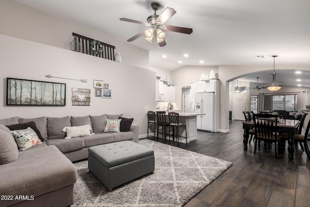 living room with vaulted ceiling, dark wood-type flooring, and ceiling fan