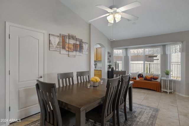 dining room featuring high vaulted ceiling, light tile patterned floors, and ceiling fan