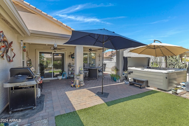 view of patio with a hot tub and ceiling fan