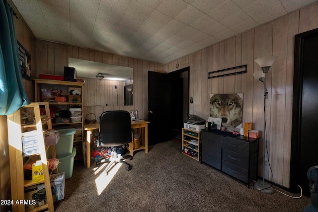 home office featuring carpet and wooden walls