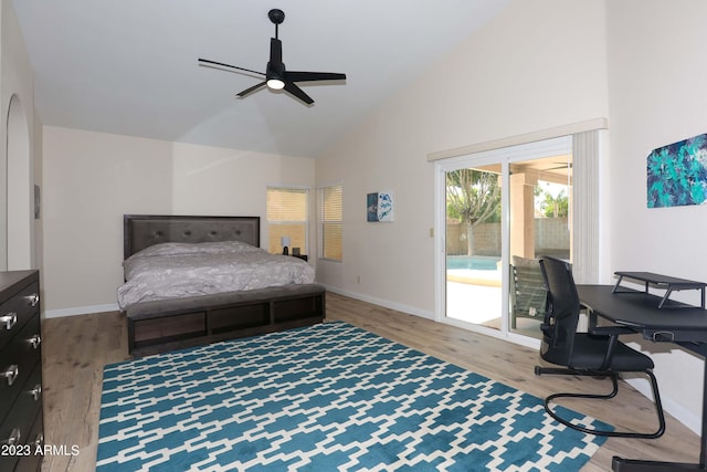 bedroom with high vaulted ceiling, wood finished floors, baseboards, and access to outside