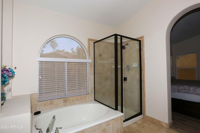 bathroom with tile patterned flooring, a garden tub, a stall shower, and ensuite bathroom