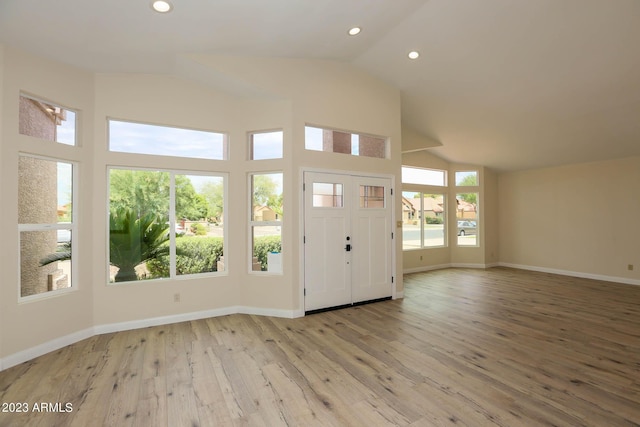 foyer entrance with hardwood / wood-style flooring, recessed lighting, baseboards, and lofted ceiling