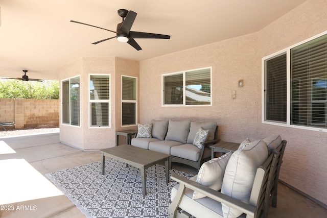 view of patio featuring an outdoor living space, a ceiling fan, and fence