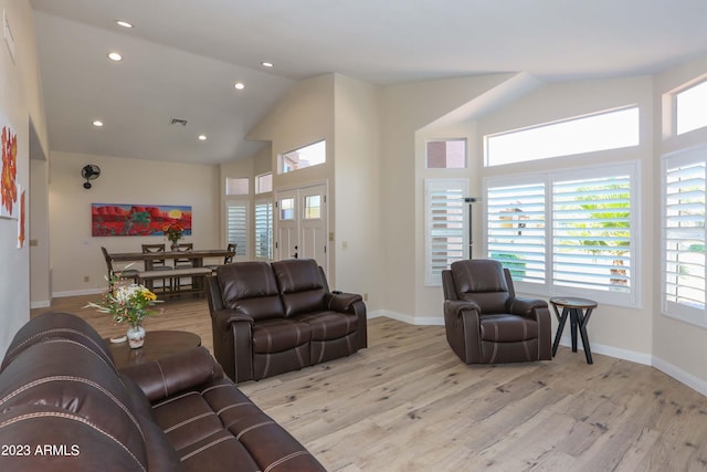 living room with recessed lighting, visible vents, baseboards, and light wood finished floors