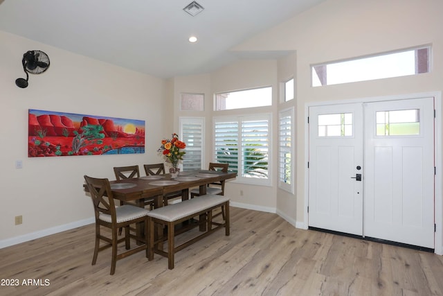 dining area featuring lofted ceiling, baseboards, visible vents, and light wood-type flooring