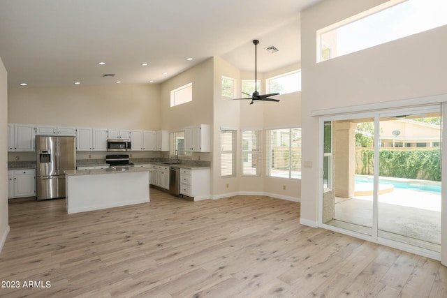 kitchen featuring a healthy amount of sunlight, visible vents, ceiling fan, appliances with stainless steel finishes, and light wood-type flooring