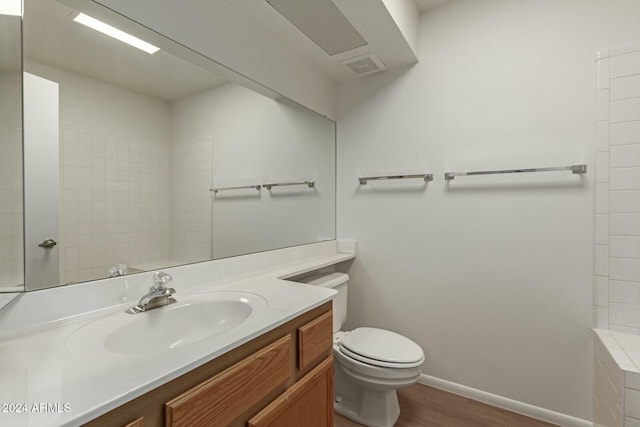 bathroom with vanity, hardwood / wood-style floors, and toilet