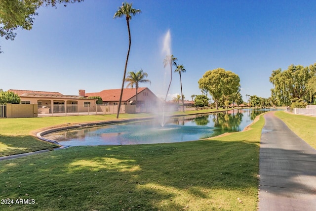 view of pool featuring a water view and a yard