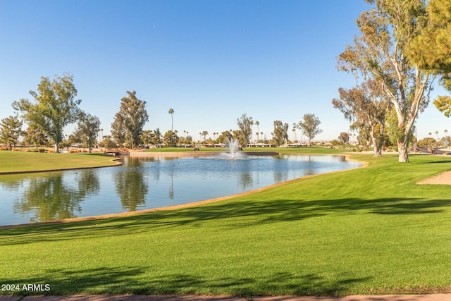 view of community with a water view and a lawn