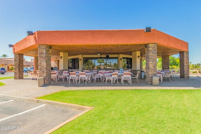 back of property with a patio area and a lawn