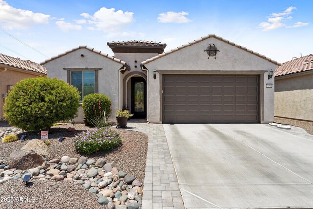 21090 N 267th Dr, Buckeye, AZ 85396 - mediterranean / spanish-style house with a garage, stucco siding, a tiled roof, and concrete driveway