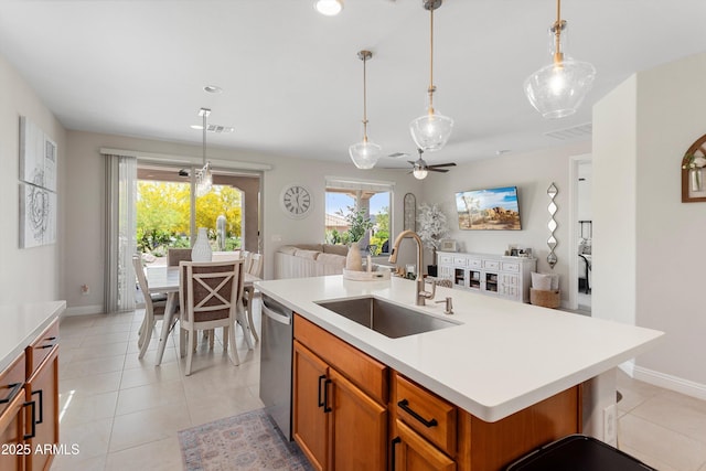 21090 N 267th Dr, Buckeye, AZ 85396 - kitchen featuring brown cabinets, dishwasher, a sink, light countertops, and open floor plan