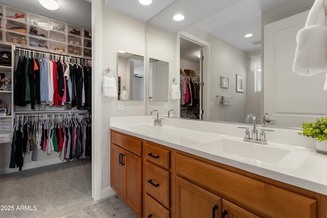 21090 N 267th Dr, Buckeye, AZ 85396 - full bath with double vanity, a sink, a walk in closet, and recessed lighting