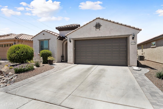 21090 N 267th Dr, Buckeye, AZ 85396 - view of front of property featuring an attached garage, driveway, a tile roof, and stucco siding