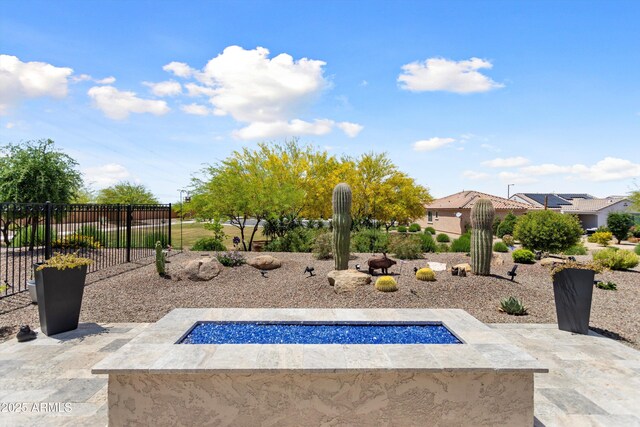 21090 N 267th Dr, Buckeye, AZ 85396 - view of home's community with fence, a fire pit, and a patio area
