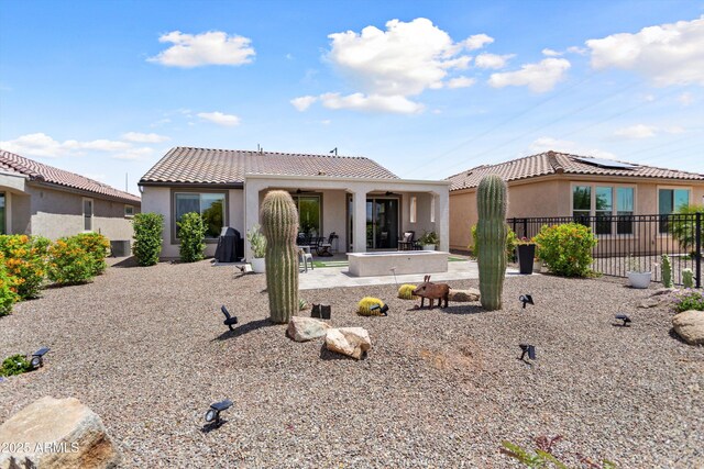 21090 N 267th Dr, Buckeye, AZ 85396 - back of house with a patio, stucco siding, a tile roof, and fence