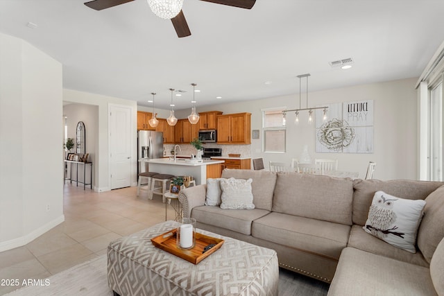 21090 N 267th Dr, Buckeye, AZ 85396 - living room featuring a ceiling fan, baseboards, recessed lighting, light tile patterned floors, and visible vents