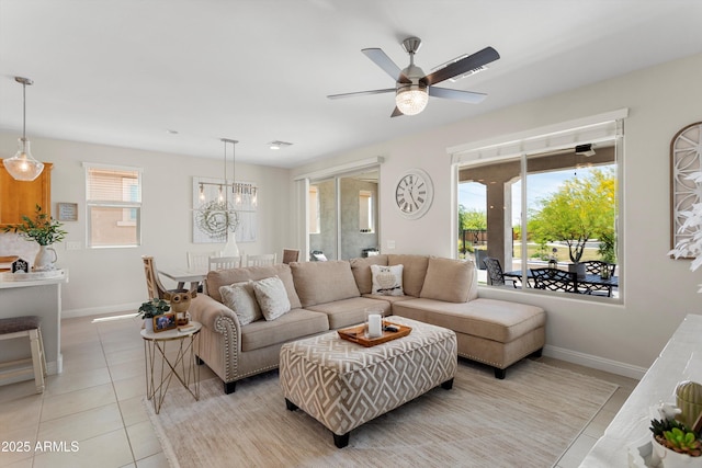 21090 N 267th Dr, Buckeye, AZ 85396 - living room with baseboards, light tile patterned floors, and ceiling fan with notable chandelier