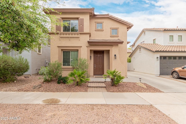 view of front facade featuring driveway and stucco siding