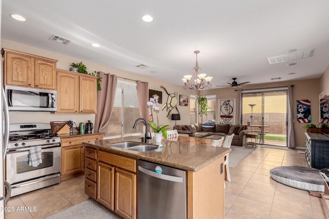 kitchen featuring open floor plan, visible vents, a sink, and appliances with stainless steel finishes