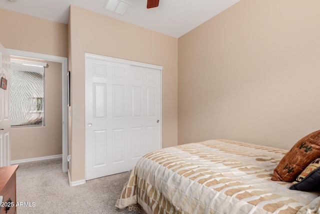 bedroom featuring baseboards, visible vents, a ceiling fan, and light colored carpet