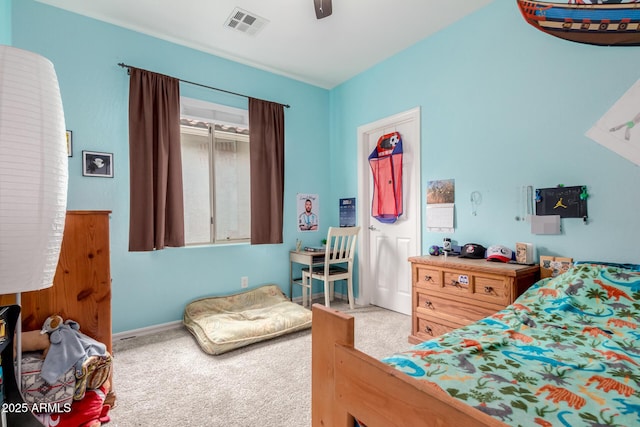 carpeted bedroom featuring baseboards, ceiling fan, and visible vents