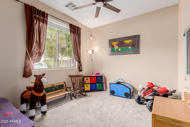 rec room with carpet flooring, visible vents, and ceiling fan