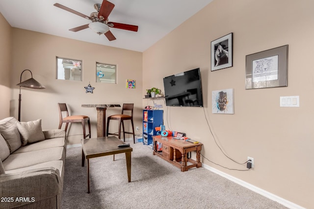 living room with carpet flooring, a ceiling fan, and baseboards