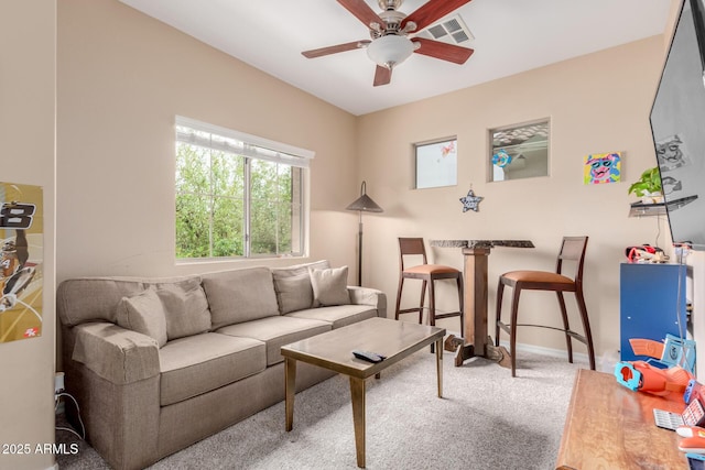 living room featuring a ceiling fan, carpet, baseboards, and visible vents