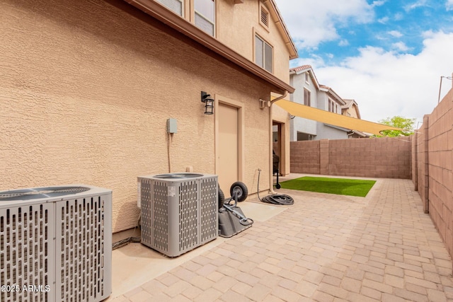 view of patio with central AC unit and a fenced backyard