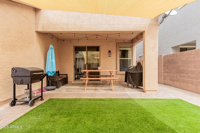 view of patio featuring grilling area and fence