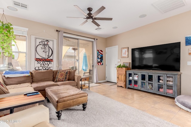 living area featuring visible vents, ceiling fan, and light tile patterned floors