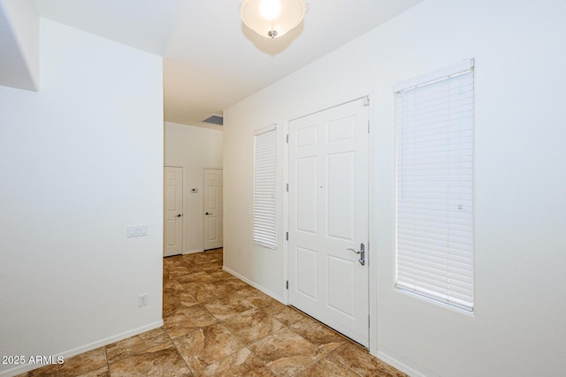 corridor featuring baseboards