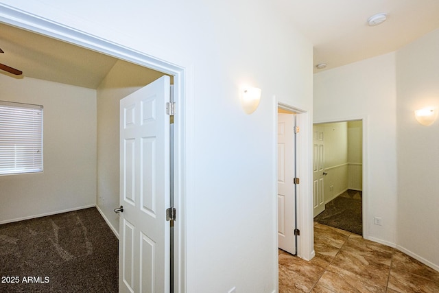 corridor with light carpet and baseboards