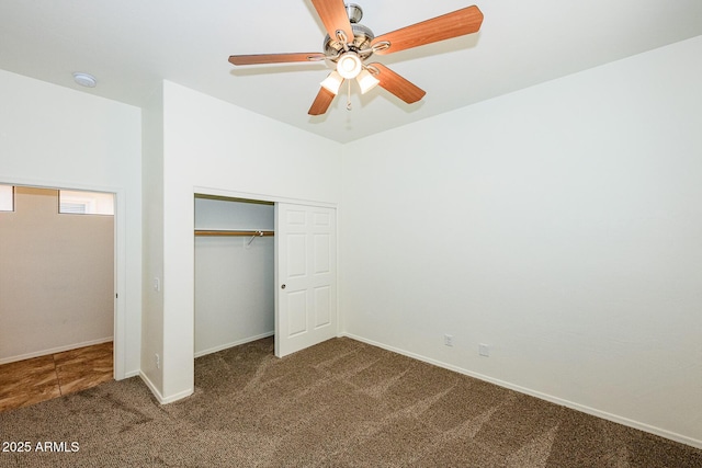 unfurnished bedroom featuring a closet, carpet flooring, lofted ceiling, baseboards, and ceiling fan