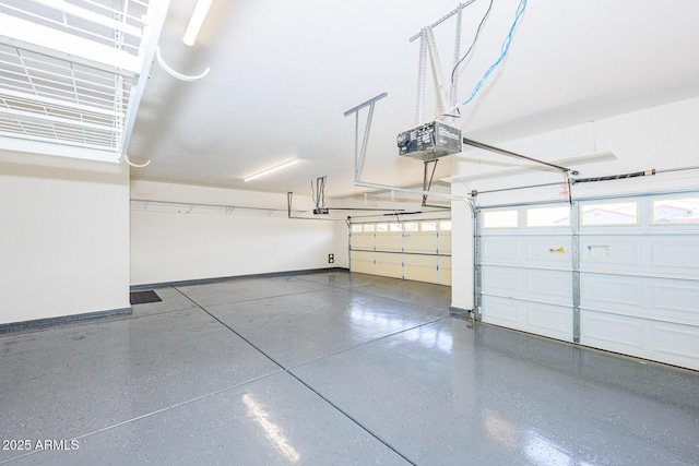 garage with baseboards and a garage door opener
