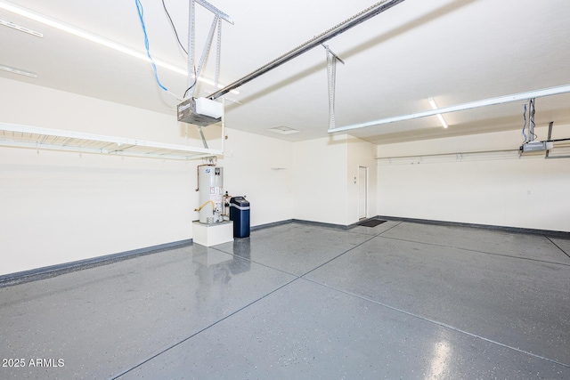 garage with a garage door opener, baseboards, and gas water heater