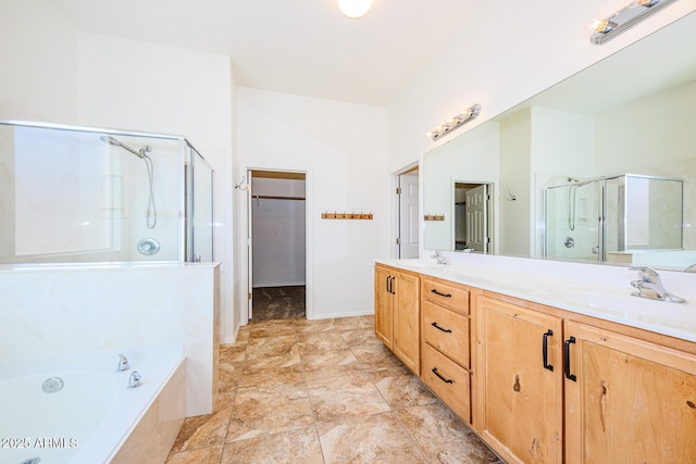 full bathroom with double vanity, a sink, a garden tub, and a shower stall