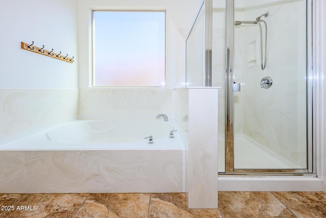bathroom featuring a stall shower, tile patterned floors, and a bath