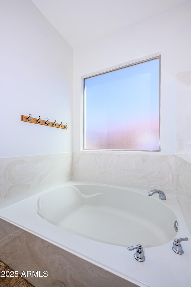 bathroom with a garden tub