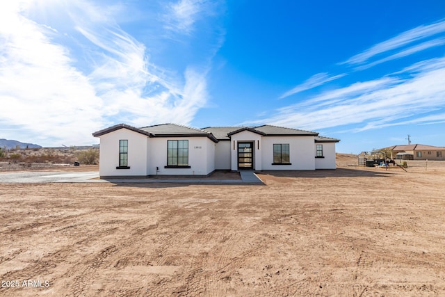 view of front of house featuring a tile roof and stucco siding