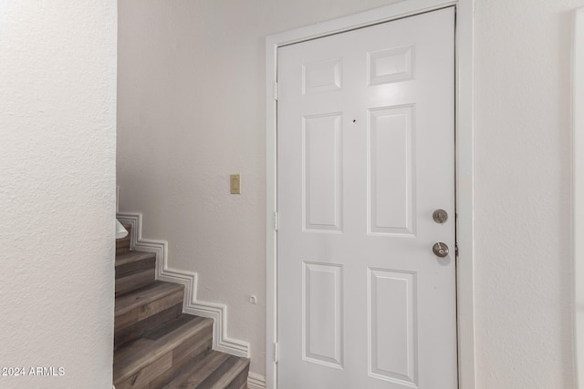 stairs featuring wood-type flooring