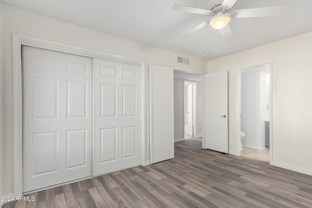 16053 N 26th Cir, Phoenix, AZ 85023 - unfurnished bedroom featuring wood finished floors, baseboards, a closet, a ceiling fan, and ensuite bath