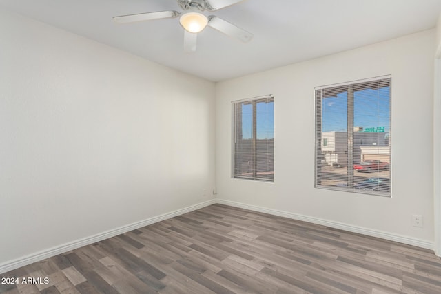 unfurnished room with hardwood / wood-style floors and ceiling fan