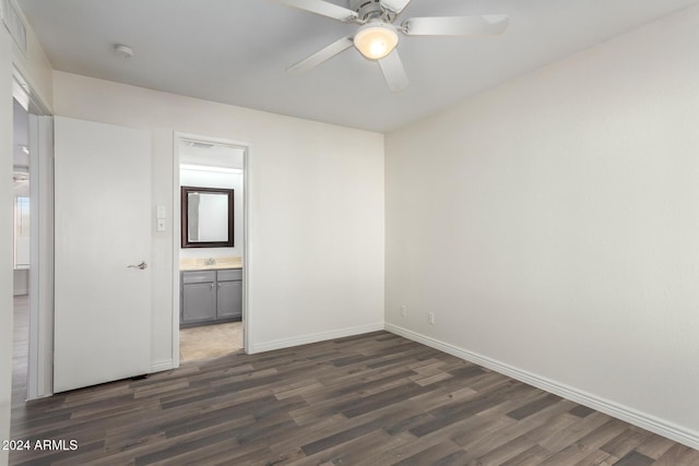 16053 N 26th Cir, Phoenix, AZ 85023 - unfurnished bedroom with dark wood-style floors, baseboards, a sink, and a ceiling fan