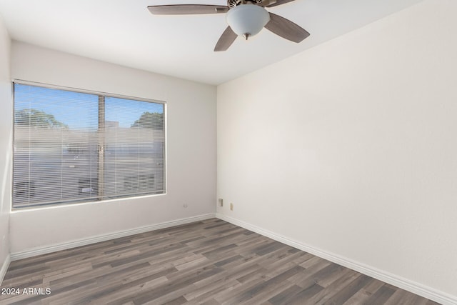 unfurnished room with dark hardwood / wood-style floors and ceiling fan